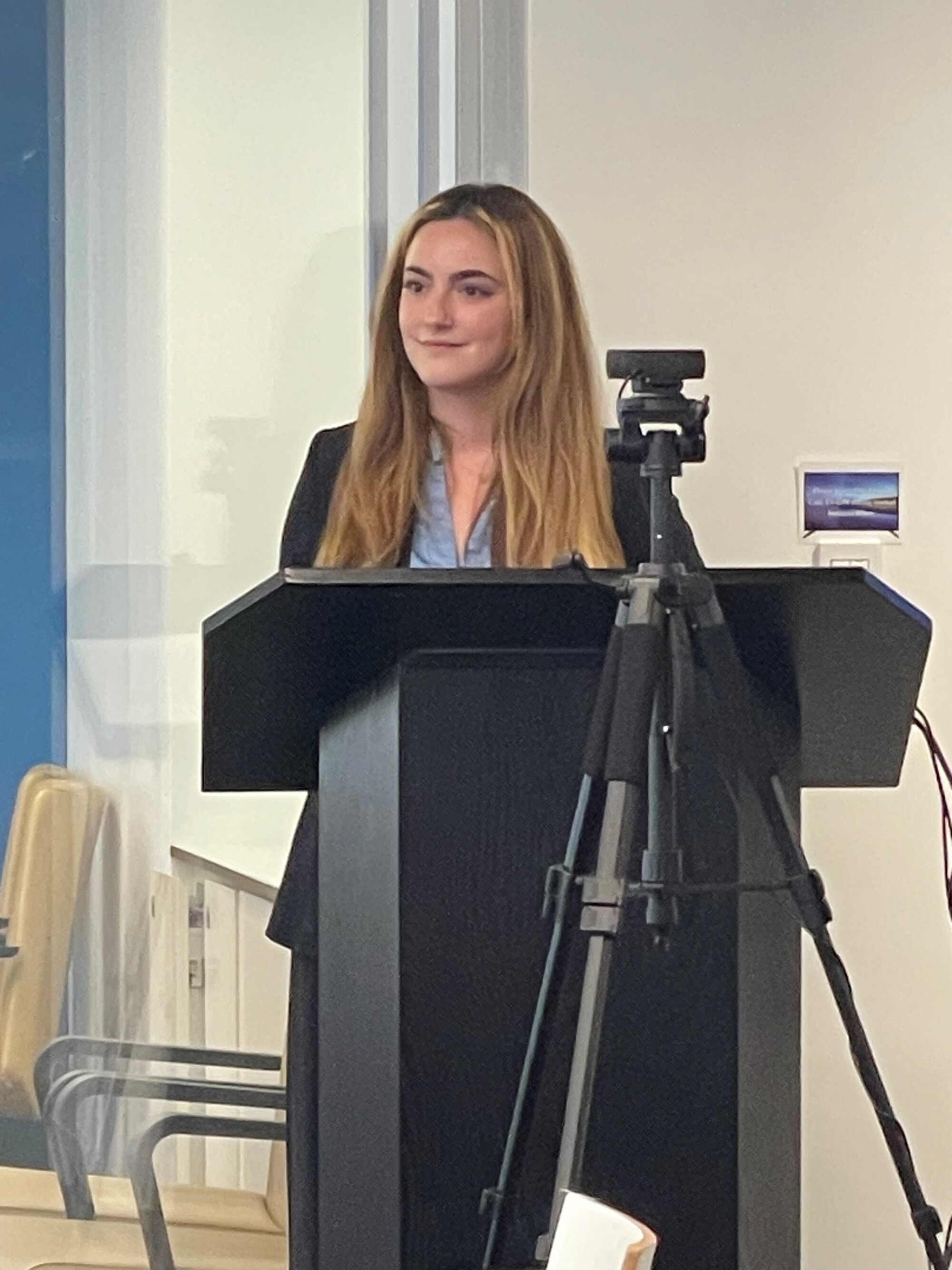 Julia Feder speaking at the podium