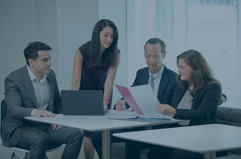 Attorneys around a table discussing a brief